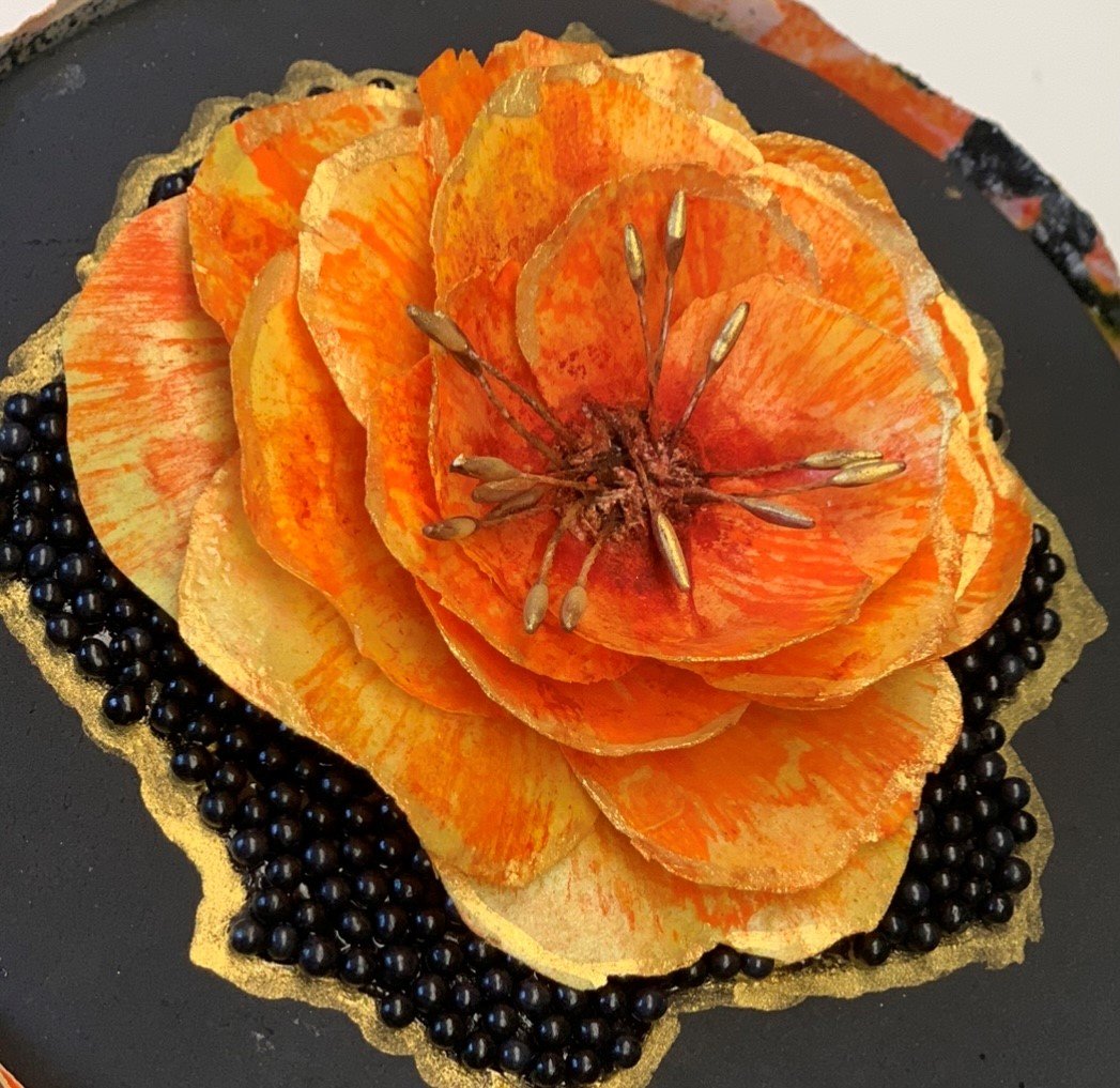The completed orange wafer-paper flower.